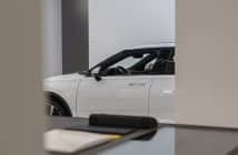 a white car is parked in a showroom