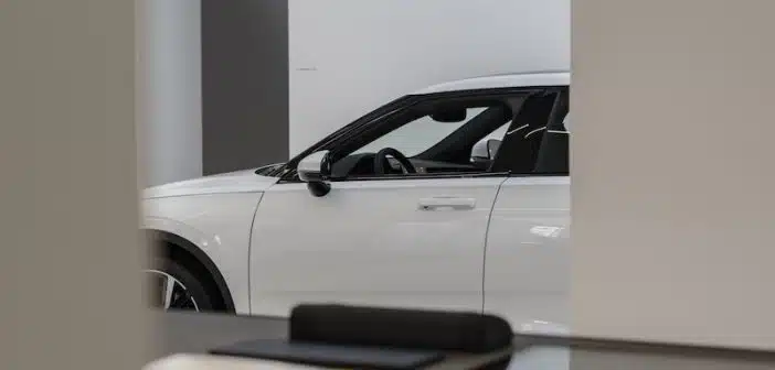 a white car is parked in a showroom